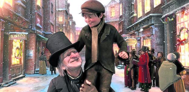 Un Scrooge reconciliado con la Navidad pasea en brazos al hijo tullido de su empleado, en la versión del célebre libro de Dickens (abajo) que Robert Zemeckis llevó al cine. /DISNEY