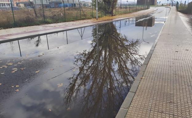 El asfaltado y la caída de hojas provoca con la lluvia una gran balsa de agua en Gómez de Salazar